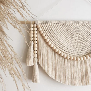Handmade macrame wall hanging – a beautifully crafted natural home decor piece. Featuring intricate knot patterns and wooden bead tassel details, this boho-inspired wall art adds texture and warmth to any space. Perfect for modern, rustic, or Scandinavian interiors. Ideal for living rooms, bedrooms, or entryways. 
