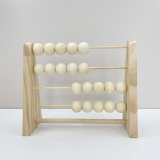 Wooden abacus toy with pastel-colored beads, placed on a neutral surface—ideal for counting and sensory play.