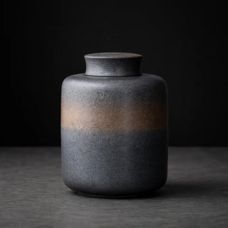 Textured black ceramic container for tea, coffee and spices.