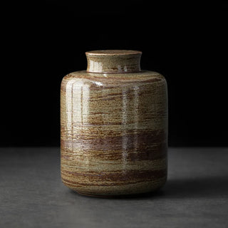 Textured khaki green ceramic container for tea, coffee and spices.