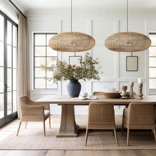 Melati oval rattan ceiling lights suspended over a dining table.