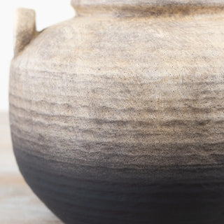 Black and natural terracotta pot with rustic ombré finish.