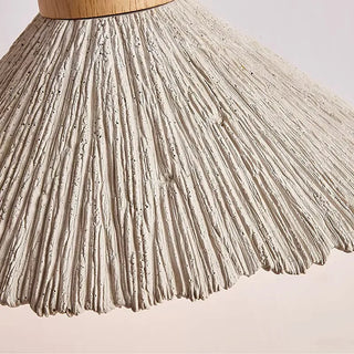 Modern cement pendant lights with wood detail and organic texture.