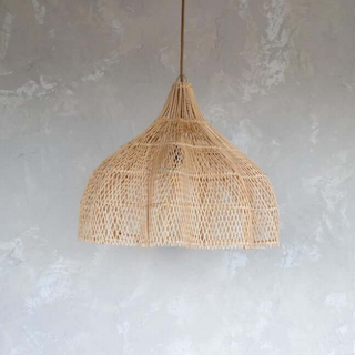 Endah Handwoven Natural Rattan Pendant Lampshade – interwoven in a creative, organic shape, this ceiling light  is a statement piece, perfect for natural home decoration. This hanging lamp comlements boho, Scandi, coastal and Wabi-Sabi aesthetics, adding warmth and texture to any space. Ideal for eco-conscious interiors.