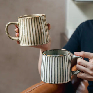 Handmade ceramic ribbed mug in natural earthy tones. Rustic, high-quality ceramic mug for coffee or tea lovers.