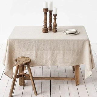 Natural linen tablecloth on a rustic wooden dining table.