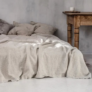 Natural flax linen flat sheet and pillowcases styled on a minimalist bed - perfect for modern, boho and scandi interiors.