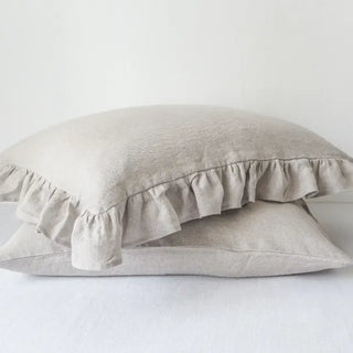 Natural ruffled linen pillowcase in white, made from 100% flax linen, styled on a soft neutral bed – available in multiple colours and sizes from Arkaim Home