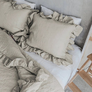 Natural ruffled linen standard pillowcase styled with matching duvet and sheets on a modern, minimalist bed for a clean, airy look.