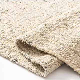 Nordic handmade wool and jute rug with a natural, heathered texture in neutral tones—ideal for minimalist and earthy home decor.
