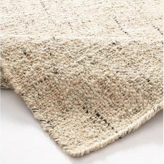 Nordic handmade wool and jute rug with a natural, heathered texture in neutral tones—ideal for minimalist and earthy home decor.