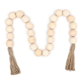 A nature-inspired oversized Wooden Bead Garland, handcrafted from natural wood and finished with bold hemp tassels. This rustic, boho décor piece adds relaxed charm to any interior, perfect for styling on trays, plant pots, candle holders, or hanging on walls and doors for a chic, earthy touch.