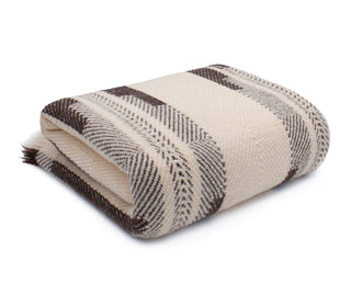 Folded thick Shevitza virgin wool blanket in creme and brown.