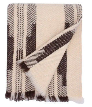 Artisan woven Shevitza wool blanket adding warmth to neutral bedroom