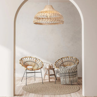 Natural Tama handwoven wicker pendant light with curved crisscross rattan weave, creating soft ambient lighting for modern and coastal interiors.