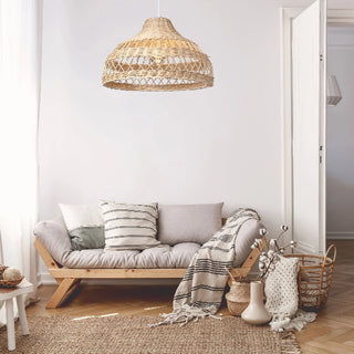 Natural Tama handwoven wicker pendant light with curved crisscross rattan weave, creating soft ambient lighting for modern and coastal interiors.
