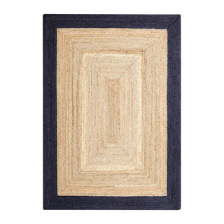 Hand-braided natural jute rug with a blue border, crafted in India—adds texture and timeless style to Scandi, coastal, or boho-inspired interiors.