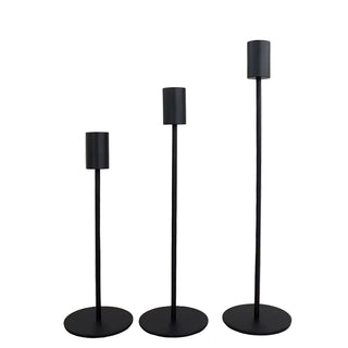 Black metal candle holders for minimalist interiors.