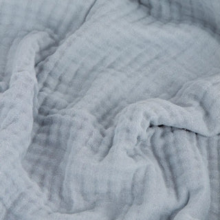 Pastel blue muslin cotton blanket with textured finish.