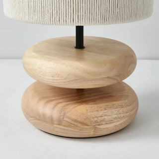 Yuni oak table lamp with smooth wooden base and handwoven fabric shade, minimalist lighting for bedside, console, or living spaces.