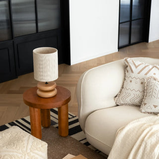 Yuni oak table lamp with smooth wooden base and handwoven fabric shade, minimalist lighting for bedside, console, or living spaces.