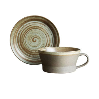 Miri stoneware mug and saucer set with spiral pattern in speckled oatmeal glaze, styled for modern and rustic tableware.