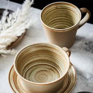 Miri stoneware mug and saucer set with spiral pattern in speckled oatmeal glaze, styled for modern and rustic tableware.