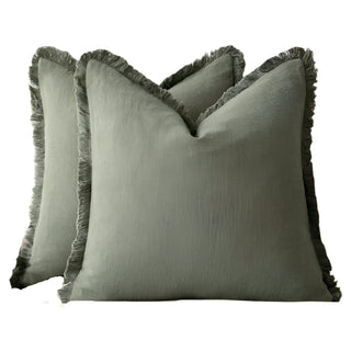 Olive green fringed cotton cushion covers, made from 100% natural cotton for a soft and breathable feel. Featuring elegant ruffled edges, these timeless cushion covers are available in two sizes for flexible styling in any home décor.