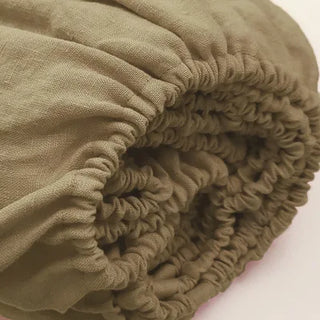 Olive green pure linen fitted sheet — breathable natural linen bedding, textured and soft, ideal for year-round comfort. Available in multiple colours and sizes at Arkaim Home. Perfect for modern, boho, Scandinavian, and wabi-sabi bedroom styles.