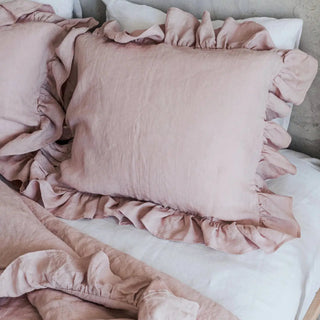 Pink ruffled linen standard pillowcase styled with matching duvet and sheets on a modern, minimalist bed for a clean, airy look.