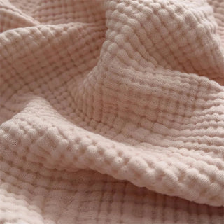 Close-up of six-layer pink gauze texture with soft fringe edges.