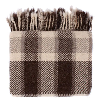 Plaid blanket with brown and beige colours and fringed edges for calm rustic interiors.