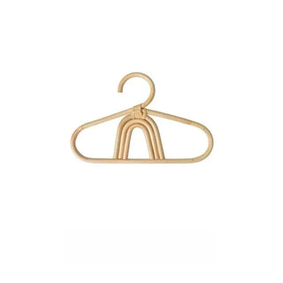 Handmade rattan clothes hangers for kids with woven boho design, nursery-sized and eco-friendly.