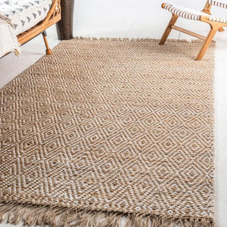 Handwoven two-tone jute rug with tassels and geometric pattern for boho, nordic, or coastal interiors.