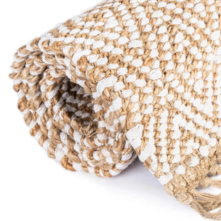 Handwoven two-tone jute rug with tassels and geometric pattern for boho, nordic, or coastal interiors.