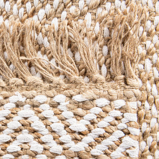 Handwoven two-tone jute rug with tassels and geometric pattern for boho, nordic, or coastal interiors.
