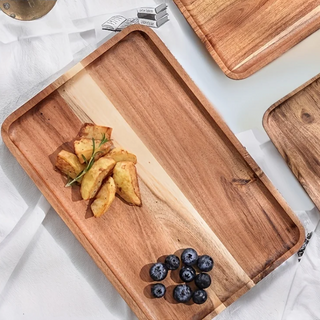 Handcrafted acacia wood square serving tray with a smooth, hand-rubbed finish. Perfect for serving bread, pastries, or breakfast in style. This natural home decor piece blends functionality with rustic charm, making it an ideal addition to any kitchen or dining space. Shop artisanal wooden serveware at our natural homeware store