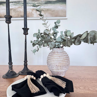 Handcrafted ribbed ceramic vase with antique white wash and urn-like silhouette displayed with eucalyptus stems. A timeless decorative piece for rustic, wabi-sabi, or minimalist interiors.