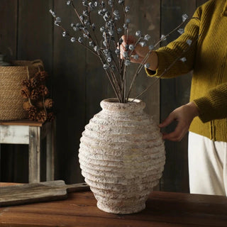 Ribbed Ceramic Vase, crafted from natural ceramic and finished in a distressed antique white wash. It adds depth and character to any setting. With its elegant silhouette and neutral tones, it complements a variety of arrangements, making it an ideal centre piece for both modern and traditional natural home décor. Perfect as a stand-alone ornament or paired with other decorative accessories.