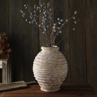 Ribbed Ceramic Vase, crafted from natural ceramic and finished in a distressed antique white wash. It adds depth and character to any setting. With its elegant silhouette and neutral tones, it complements a variety of arrangements, making it an ideal centre piece for both modern and traditional natural home décor. Perfect as a stand-alone ornament or paired with other decorative accessories.