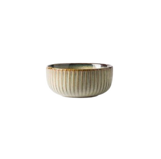Kiln-glazed ceramic bowl with ribbed surface and earthy, neutral tones inspired by sand and sea—ideal for serving rice, noodles, or shared meals.