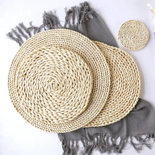Natural round handwoven corn husk placemats and coasters, eco-friendly and heat-resistant for stylish table protection.