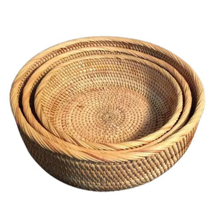Set of round handwoven natural rattan storage baskets in three sizes, ideal for organising or serving snacks in an eco-friendly home.