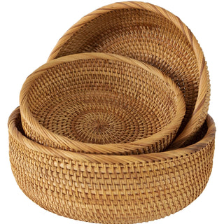 Set of round handwoven natural rattan storage baskets in three sizes, ideal for organising or serving snacks in an eco-friendly home.