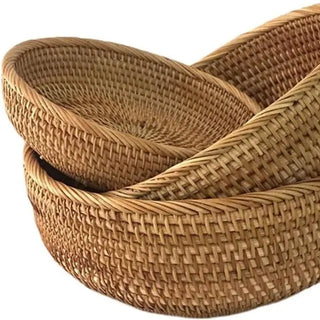 Set of round handwoven natural rattan storage baskets in three sizes, ideal for organising or serving snacks in an eco-friendly home.