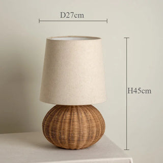 Table lamp with wicker base and beige shade, shown with dimensions.