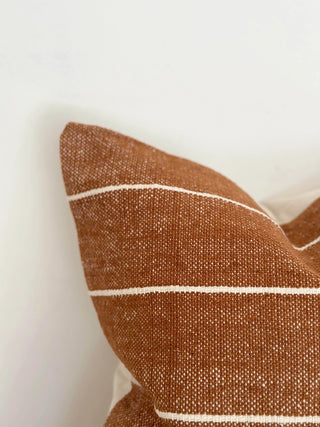 Burnt orange striped cushion cushion for natural and modern interiors.