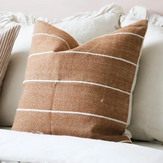 Warm terracotta and cream stripe cushion in soft cotton fabric for modern and contemporary interiors.