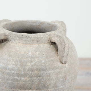 Rustic terracotta pot with matte texture and loop handles.