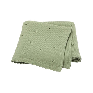 Gigi cotton knit baby blanket folded in soft sage green.